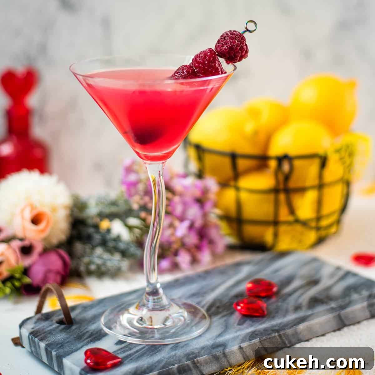 Raspberry lemon drop martini garnished with raspberries.