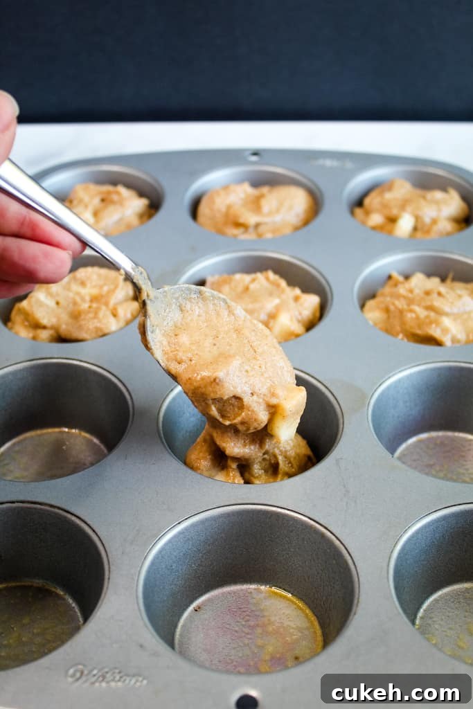 gluten free apple muffins portioned in a muffin tin