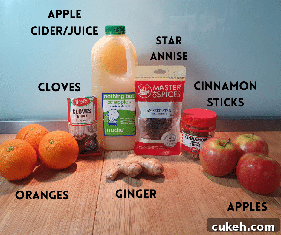 Mulled apple cider ingredients, oranges, whole cloves, ginger root, apple cider or juice, whole star annise, cinnamon sticks and apples.