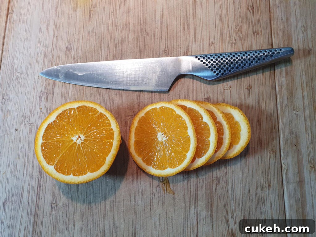 slicing up orange into rounds.