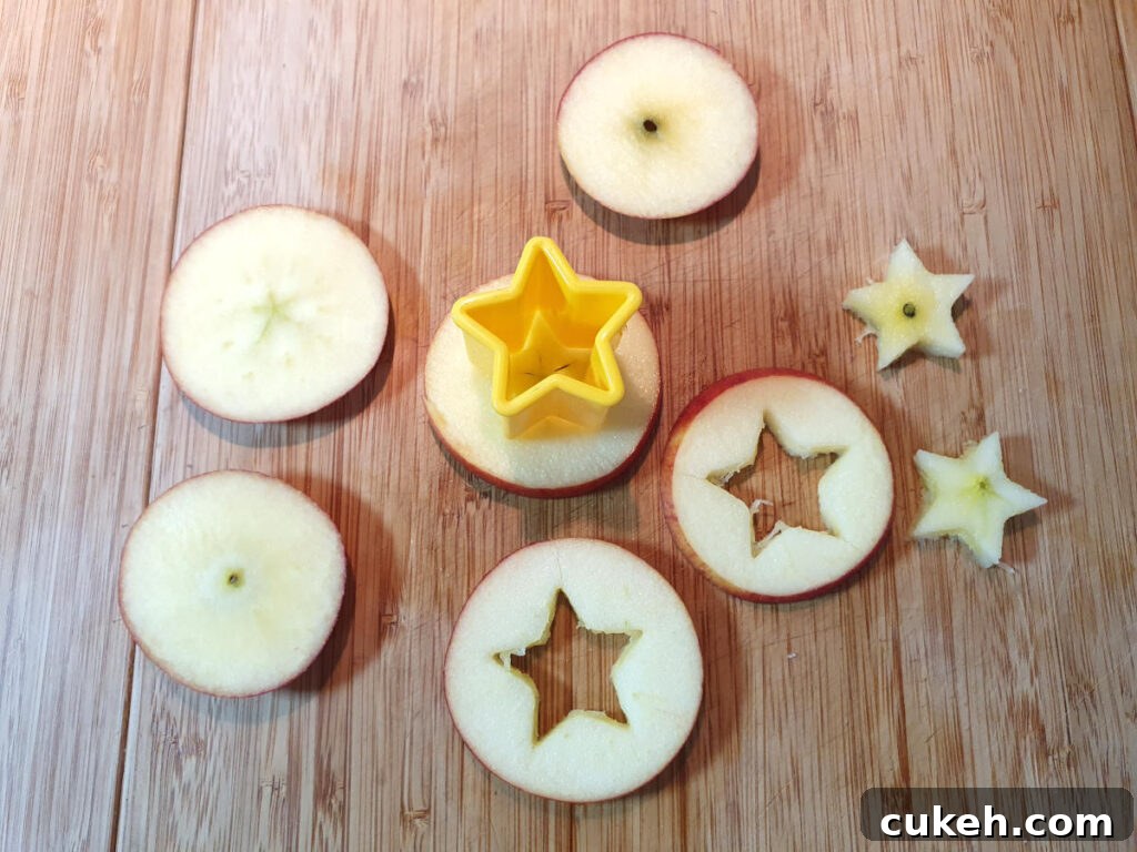 slicing up apples and cutting out small apple stars using a star cookie cutter.