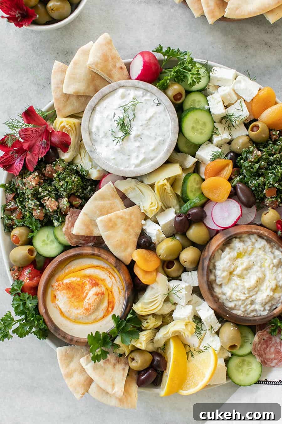 Authentic Greek Mezze Platter: Meze Recipes & Serving Guide 2 Mezze Platter with yogurt and pretty toppings like olives, radish, bread.