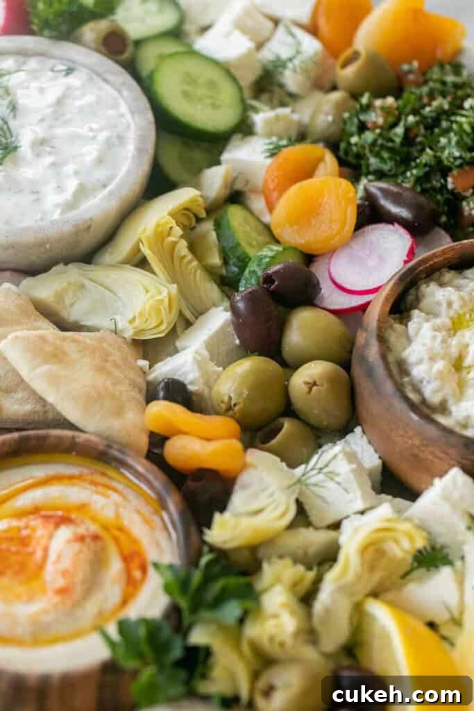Authentic Greek Mezze Platter: Meze Recipes & Serving Guide 5 Greek mezze platter filled with olives, cheese, pita and dips.