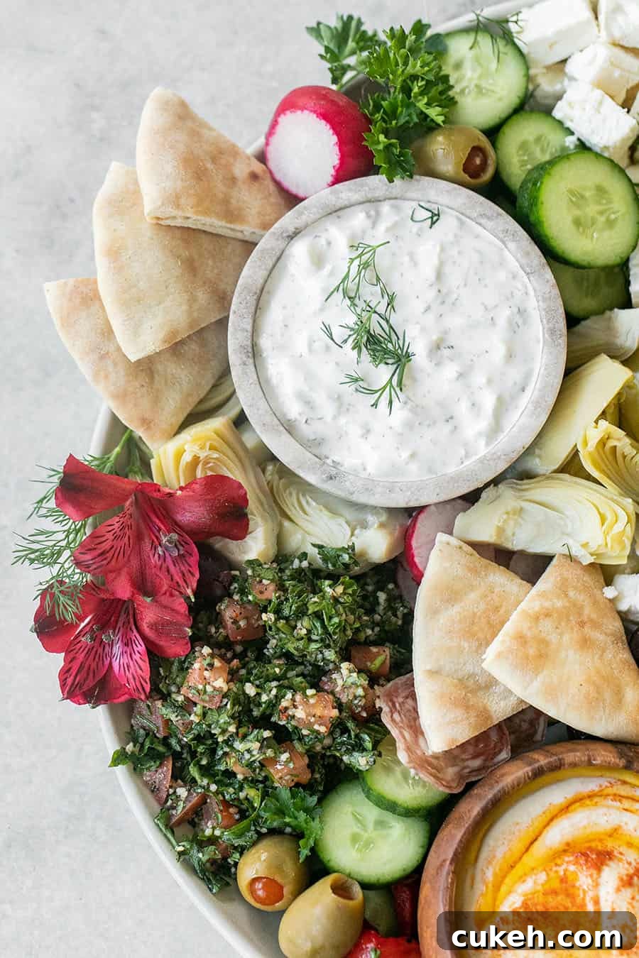 Authentic Greek Mezze Platter: Meze Recipes & Serving Guide 8 Homemade Greek mezze board with colorful dips and vegetables.