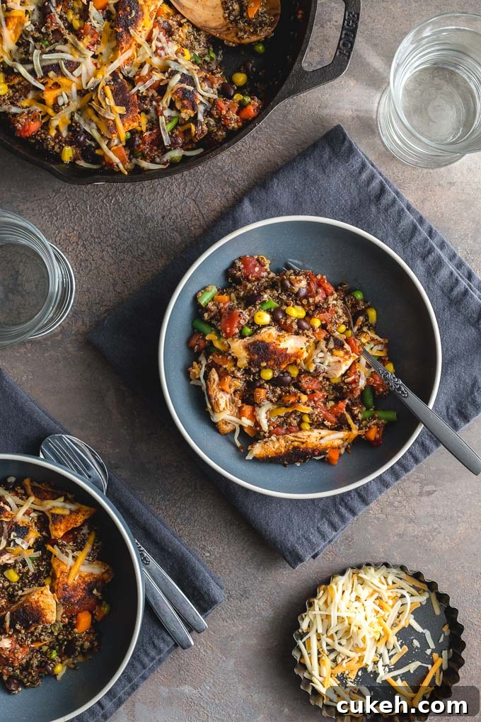 Overhead view of salmon and quinoa casserole in a skillet and served in blue bowls.