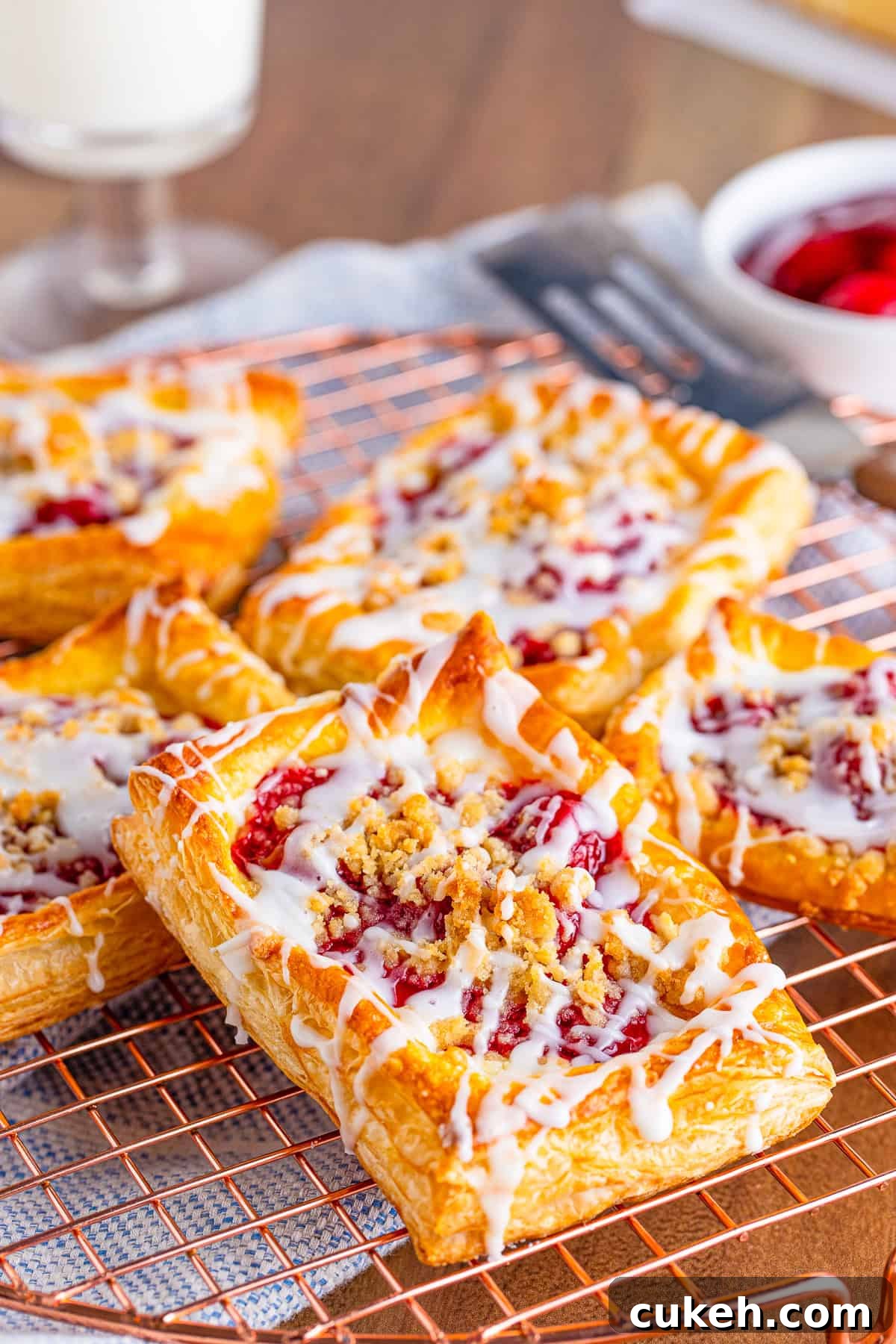 Cherry Danish with Cream Cheese: Flaky Pastry Recipe 2 Layers of Cherry Danish on top of one another on wire rack.