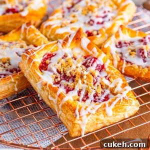 Cherry Danish with Cream Cheese: Flaky Pastry Recipe 8 Square image close up of one danish on wire rack.