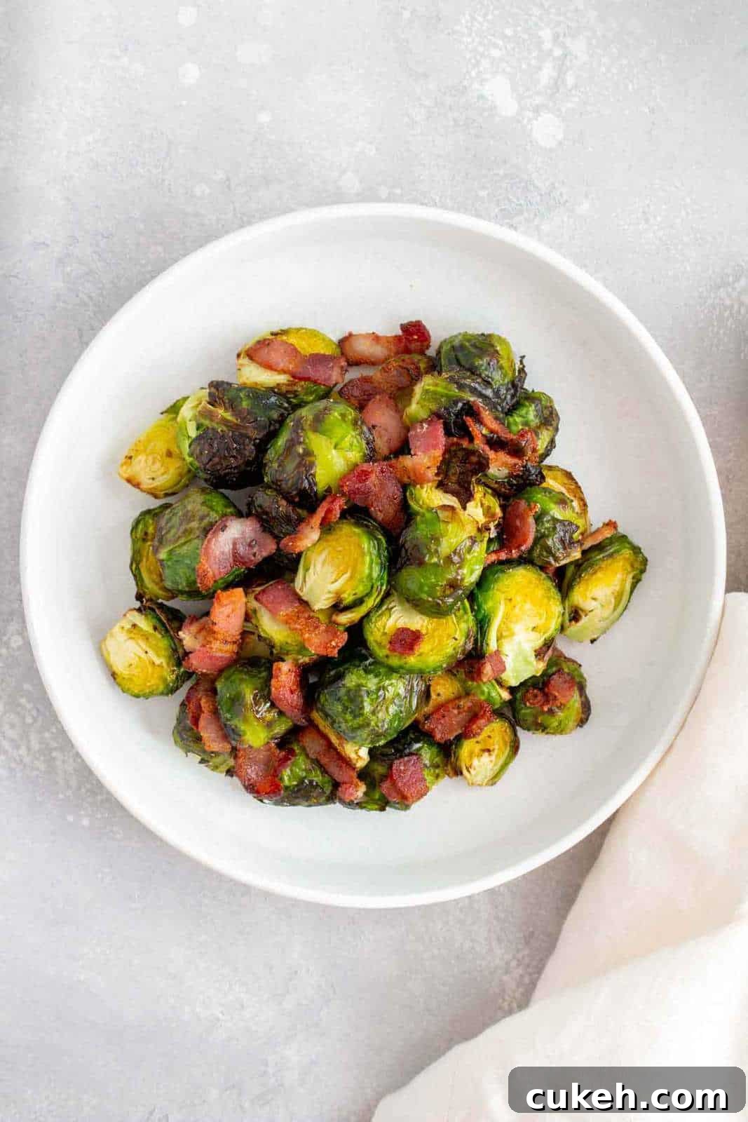 A plate of air fryer brussels sprouts with bacon.