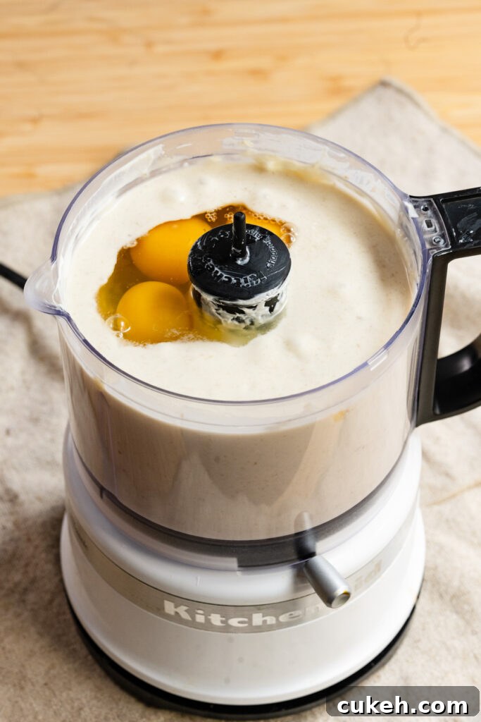 Eggs and banana batter in a mini food processor.
