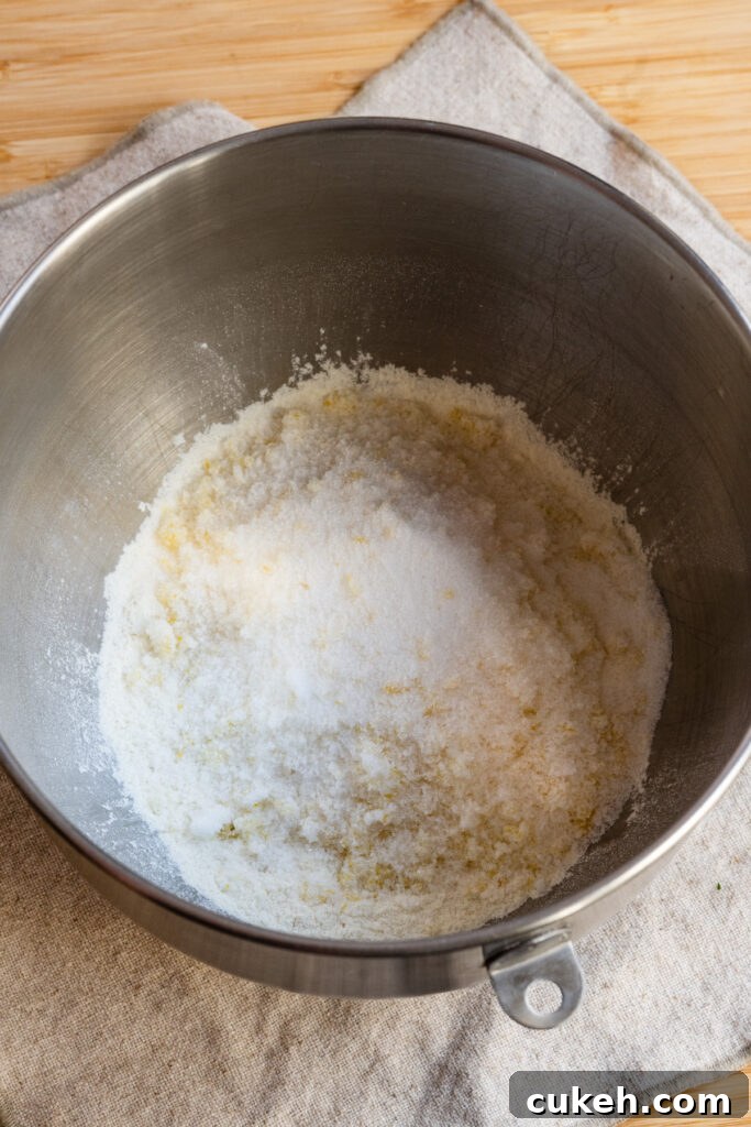 Flour and sugar in the bowl of a stand mixer.