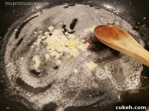 Minced garlic is quickly cooked in melted butter to begin making the sauce. Minced garlic is quickly cooked in melted butter to begin making the sauce.