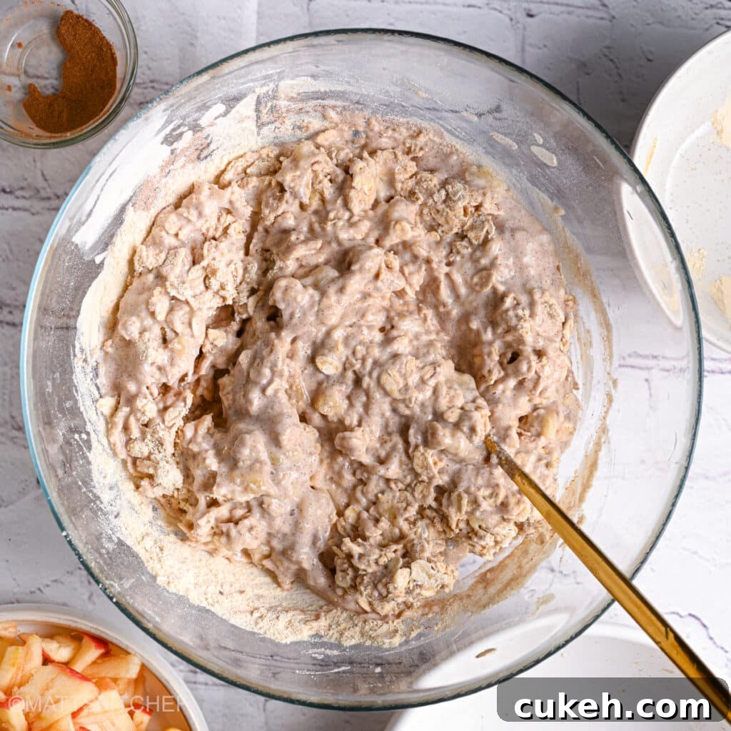 Stirring dough after adding oats and oat flour