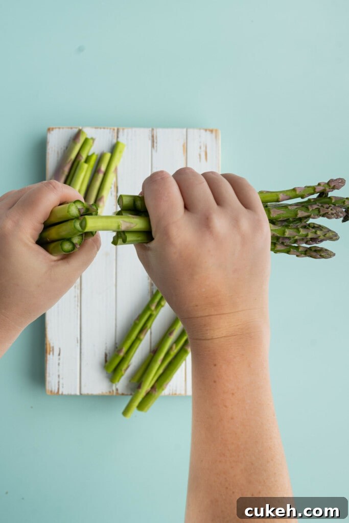 Snapping ends off of asparagus to roast with honey gold potatoes.