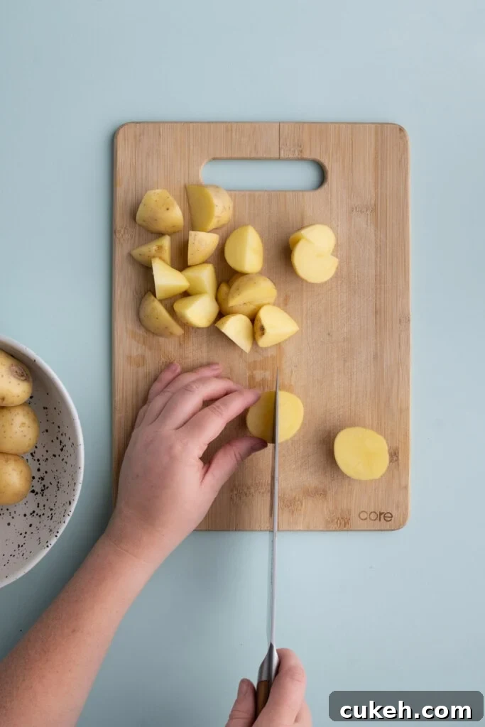 Slicing honey gold potatoes to prep for roasting.