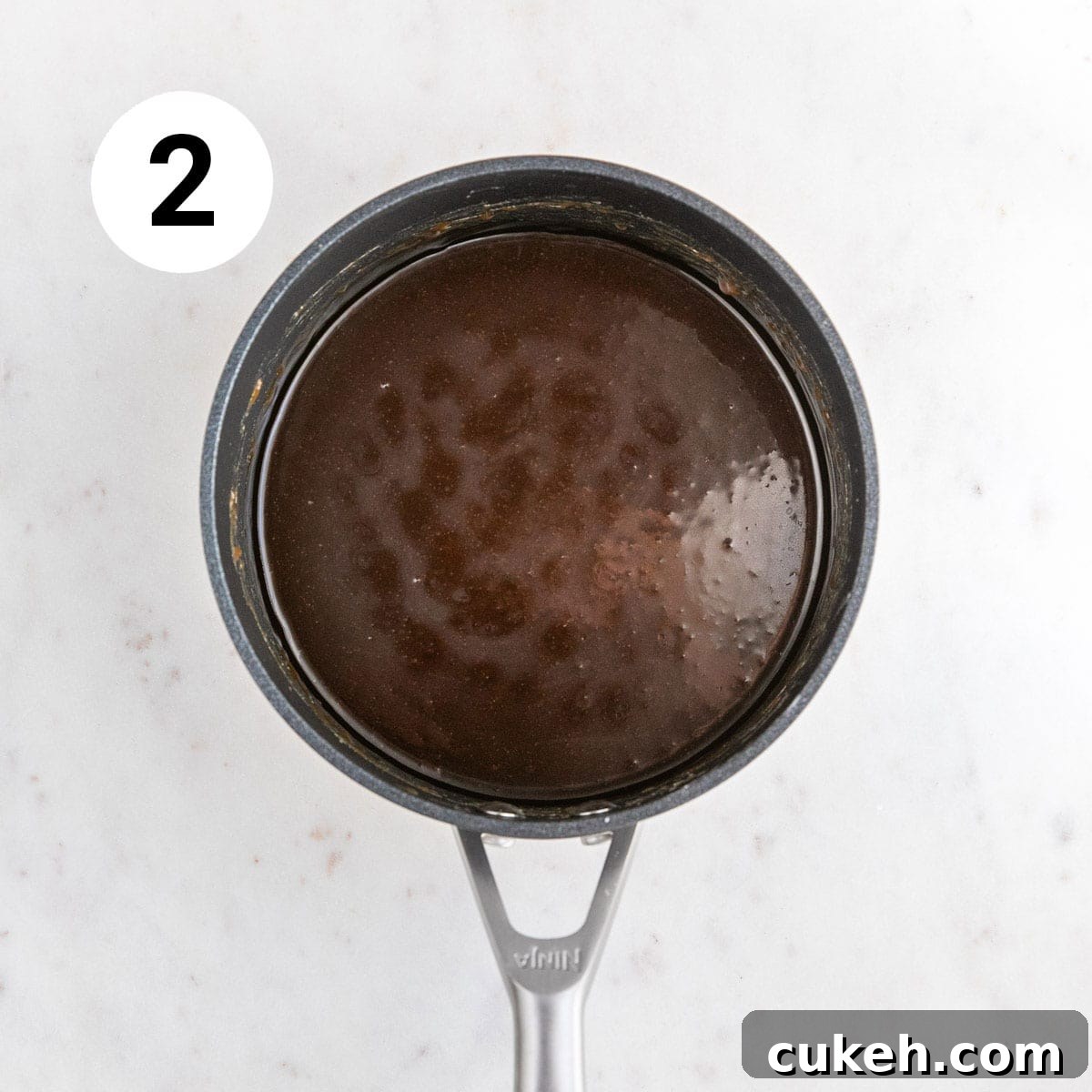 Saucepan with cooked vegan caramel sauce.