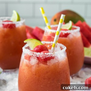 Watermelon Mango Margarita Recipe — Fresh Summer Cocktail 2 watermelon mango margaritas with yellow straws and lime garnishes