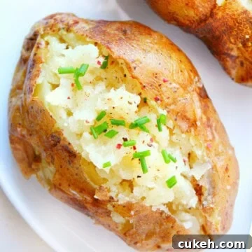 Quick Microwave Baked Potatoes: Crispy Skin in 10 Minutes 7 Baked potato on a plate.