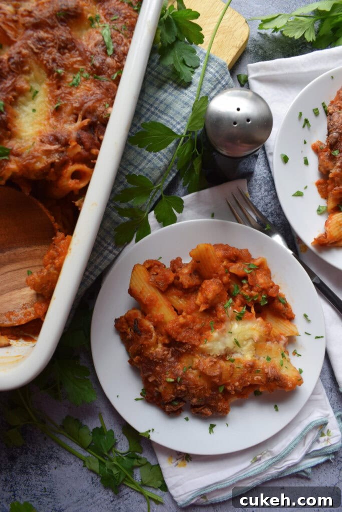 Pasta bake on a white plate with a casserole dish.
