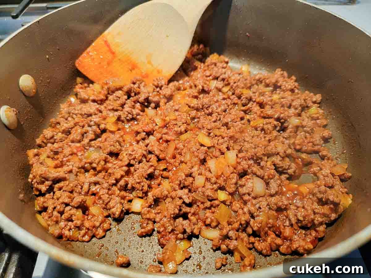 sloppy joes cooking in a skillet.