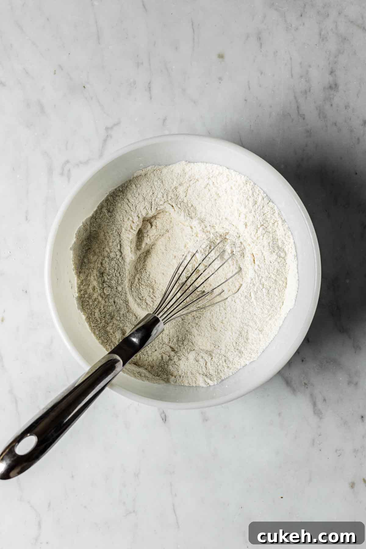 A mixing bowl with dry ingredients for macarons.