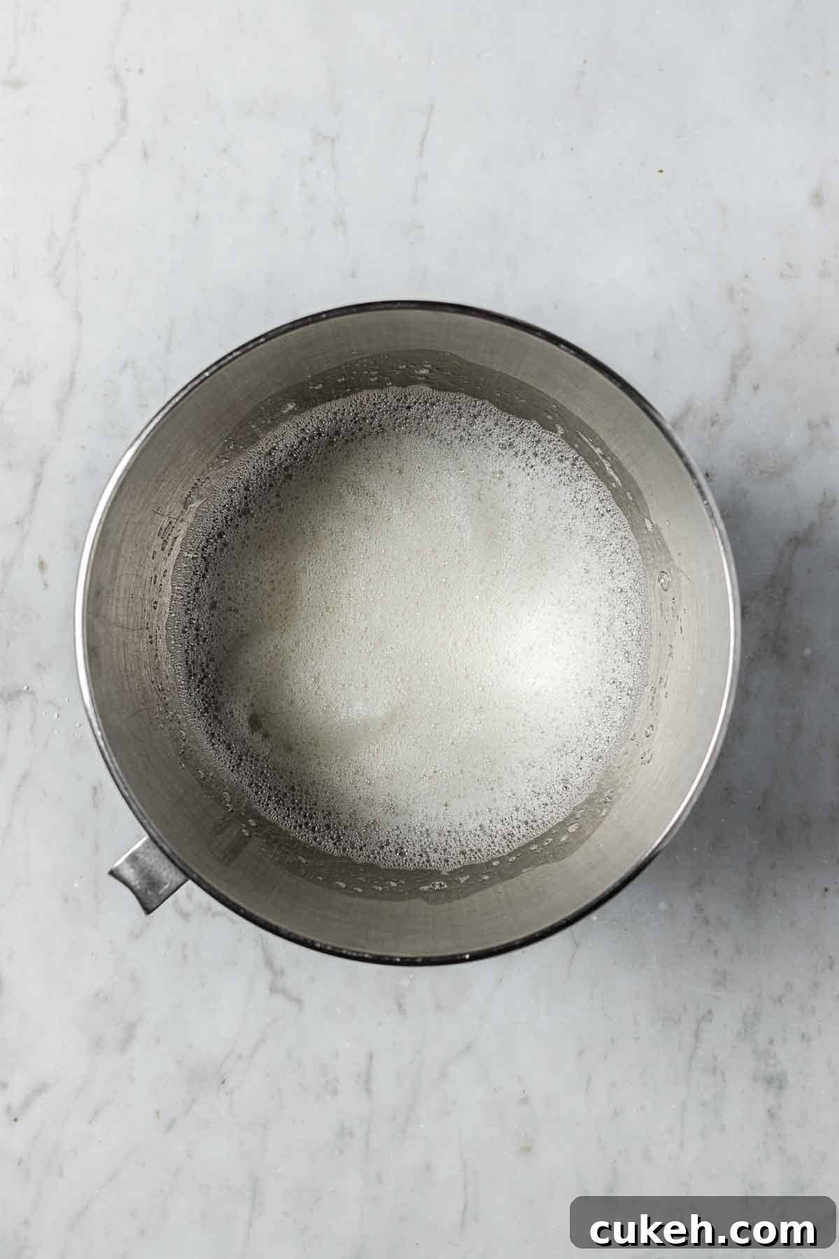 A mixing bowl with frothy egg whites for meringue.