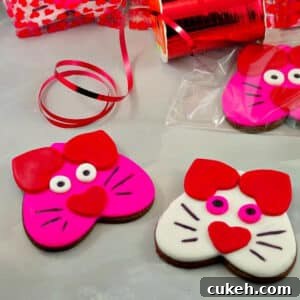pink and white cat cookies on grey surface
