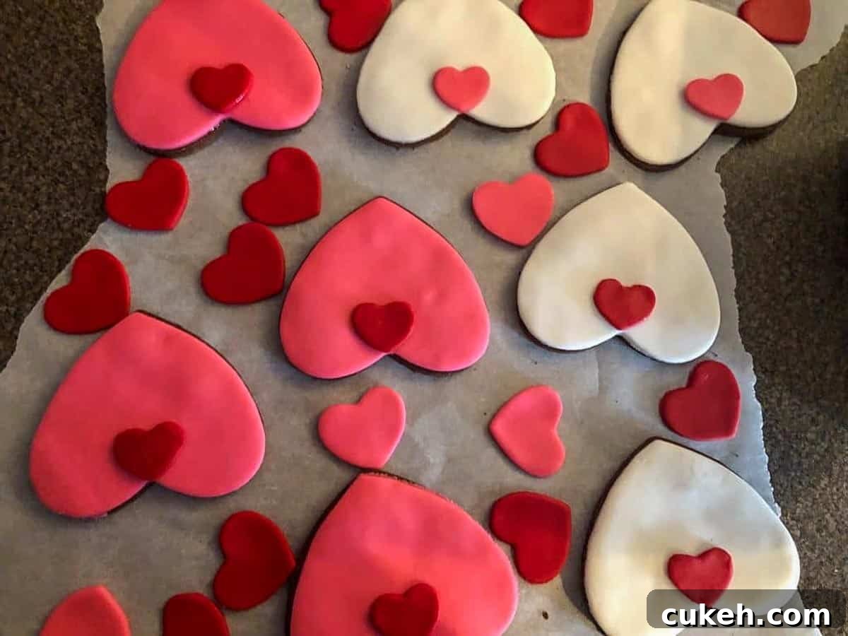 small heart cat noses being put on heart-shaped cookies