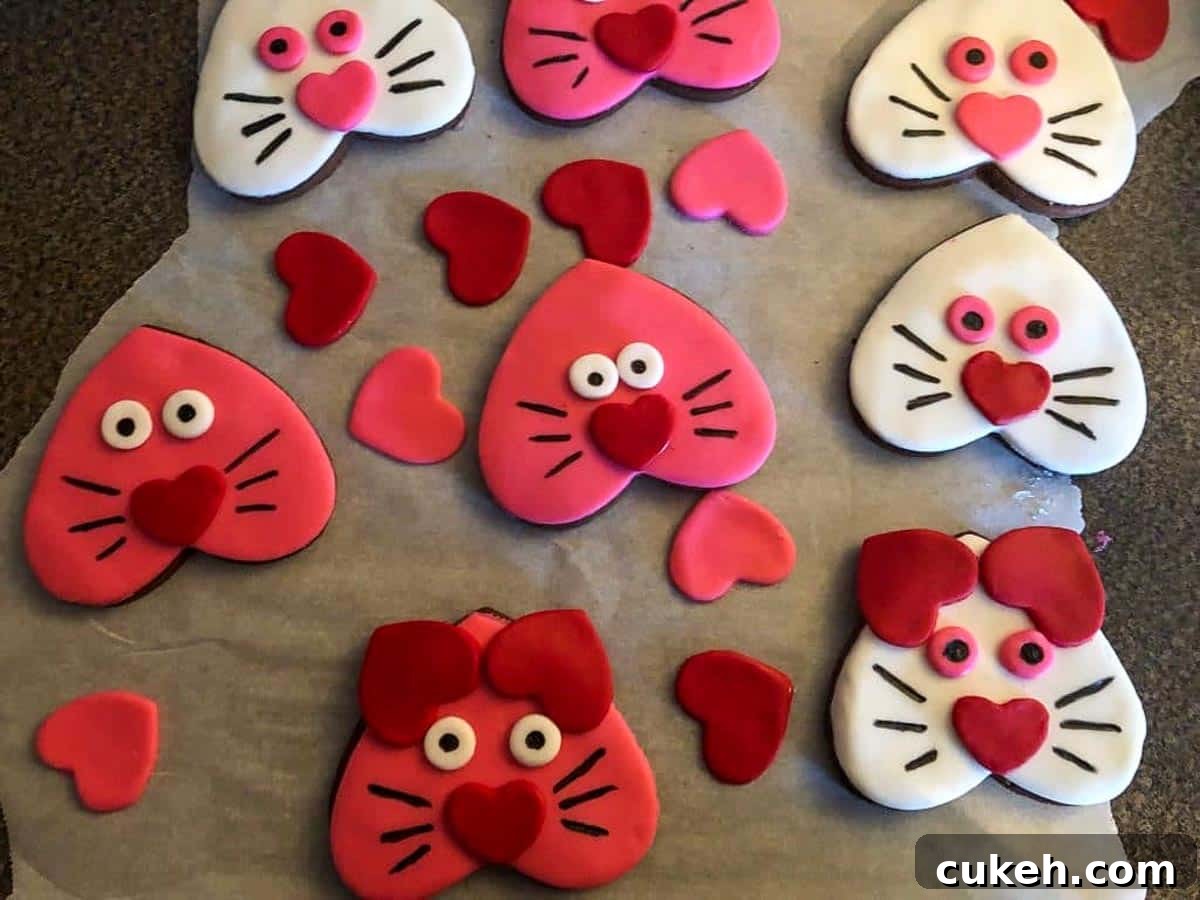 cat cookies with ears, eyes and faces drawn on
