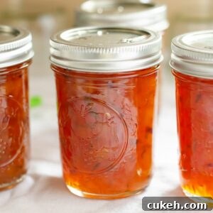 Half pint canning jars filled with Peach Lime Chutney.