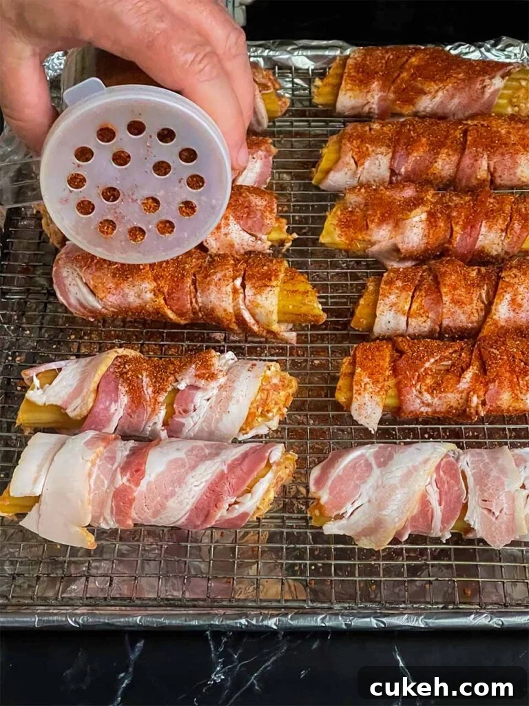 Smoked Shotgun Shells: Savory Sausage-Stuffed Appetizer Recipe 6 Covering the stuffed shells with barbecue rub.