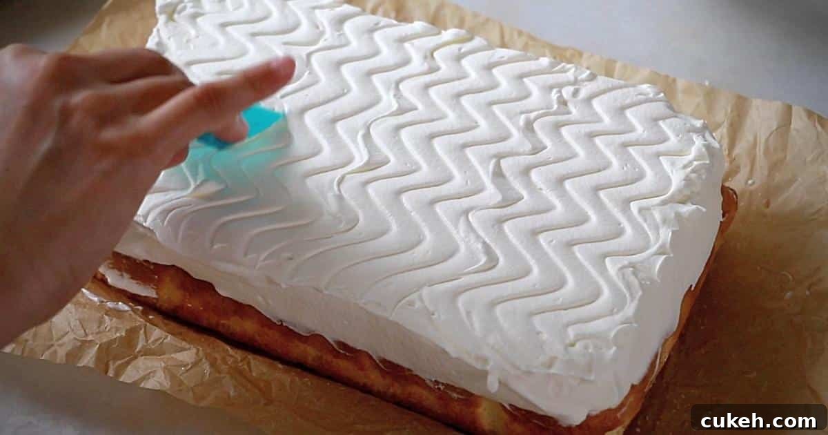 frosting whipped cream on top of tres leches cake