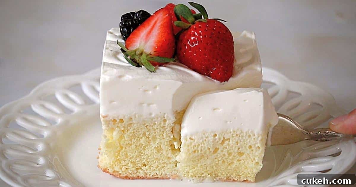 cutting a tres leches cake on a plate with a fork