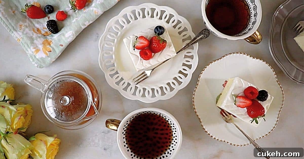 tres leches cakes on plates with teas, berries and flowers