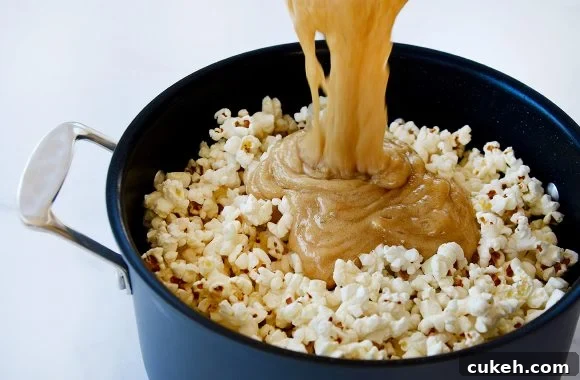 Homemade Caramel Corn Recipe for Perfect Crunch 3 Caramel being poured over popcorn in stockpot