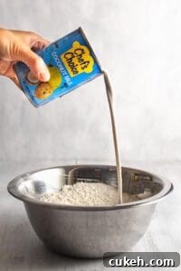 Pouring a can of coconut milk into a bowl