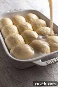 Coconut sauce being poured over dough