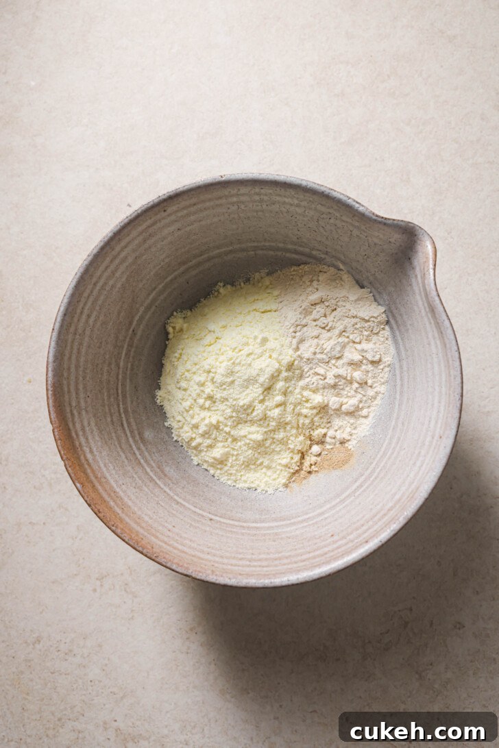 Milk powder, pancake mix and cardamom in a bowl for making Gulab Jamun.