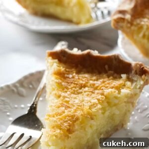 Custard pie slice with golden crust on a plate, fork beside it.