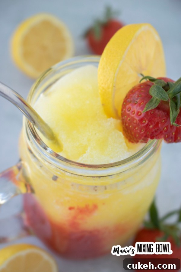 Overhead shot of frozen strawberry lemonade in mason jar glass