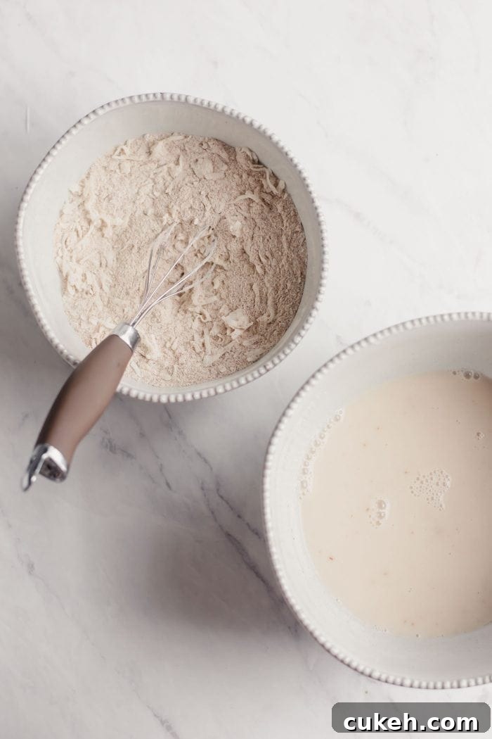 One bowl with flour and coconut, one bowl with almond milk.