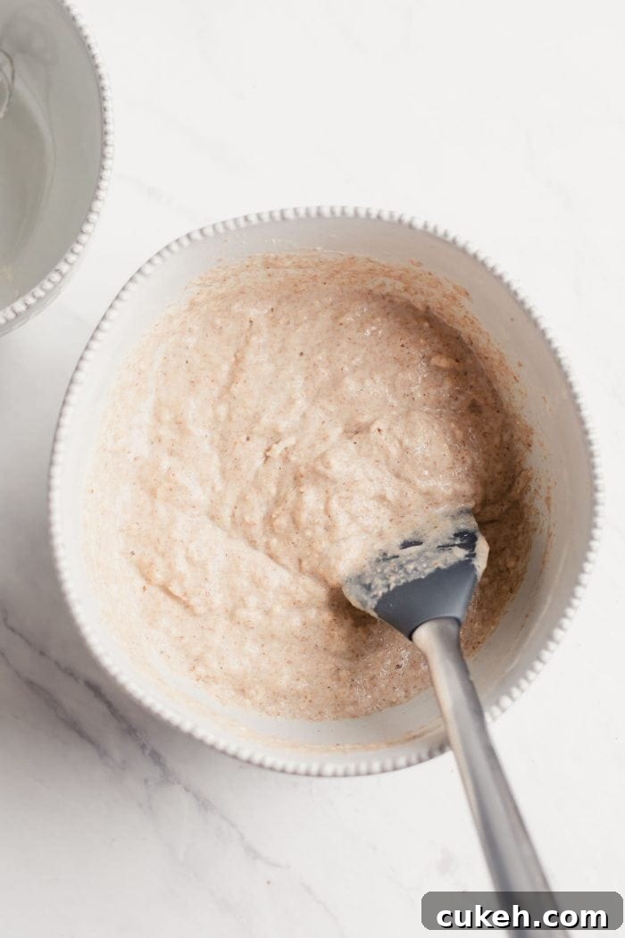 Thick pancake batter in a white bowl.