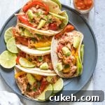 Instant Pot Chicken Fajitas — Quick Weeknight Recipe (Video) 6 a plate filled with instant pot chicken fajitas