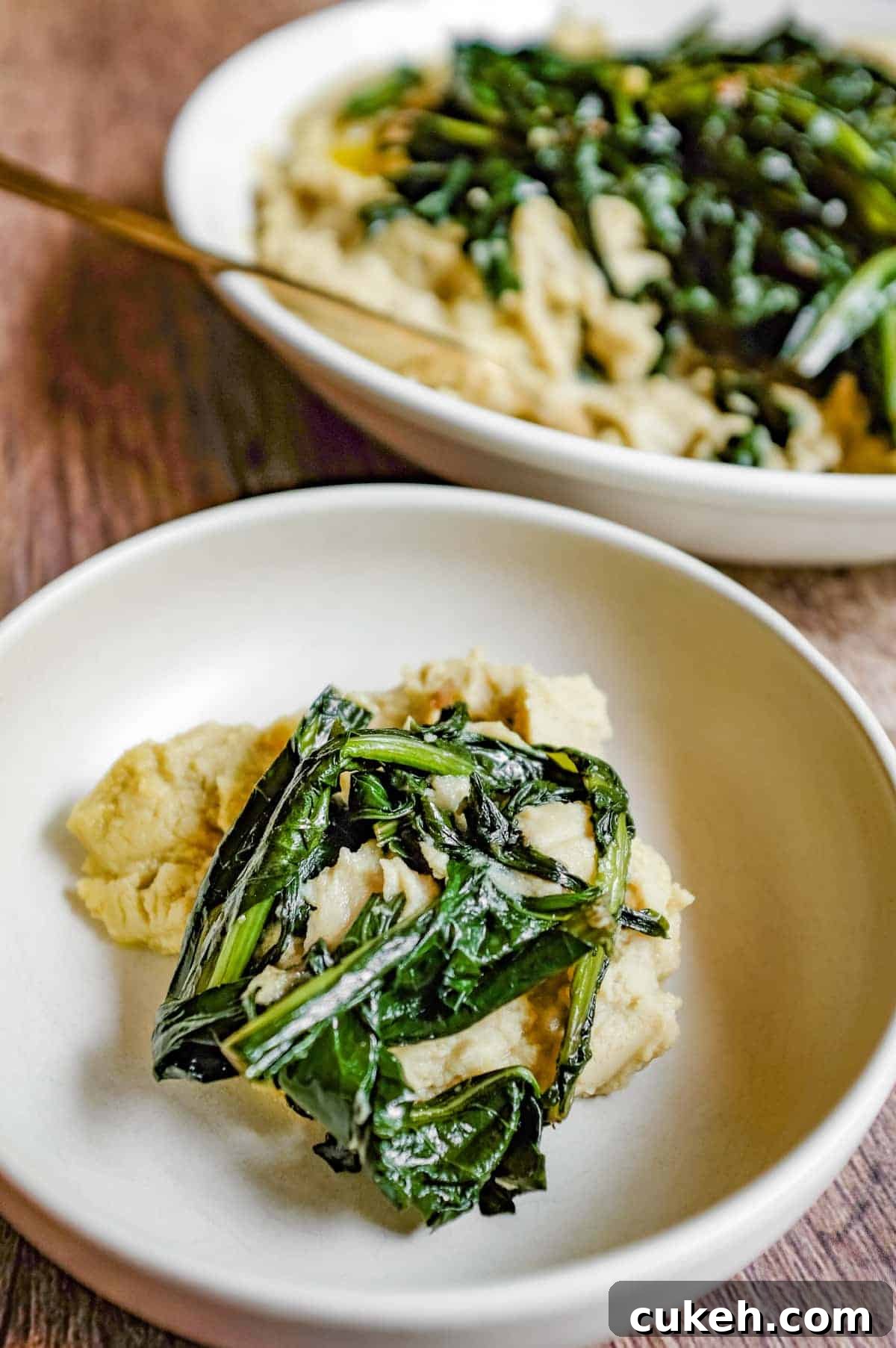 Two bowls of fava bean puree and chicory greens