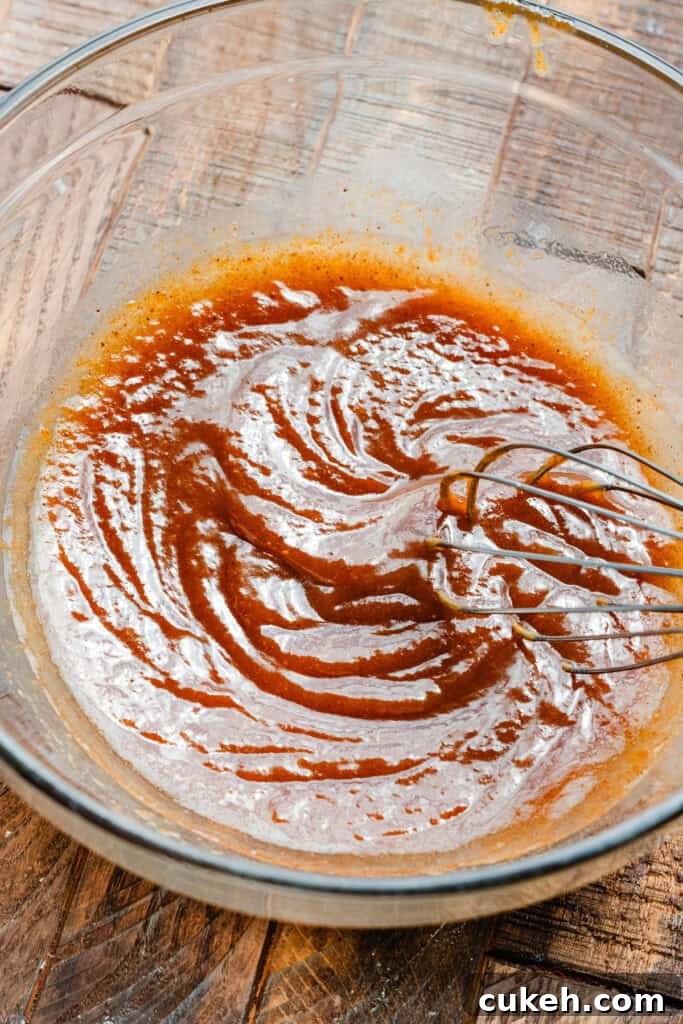 A bowl of the wet ingredients being whisked together.