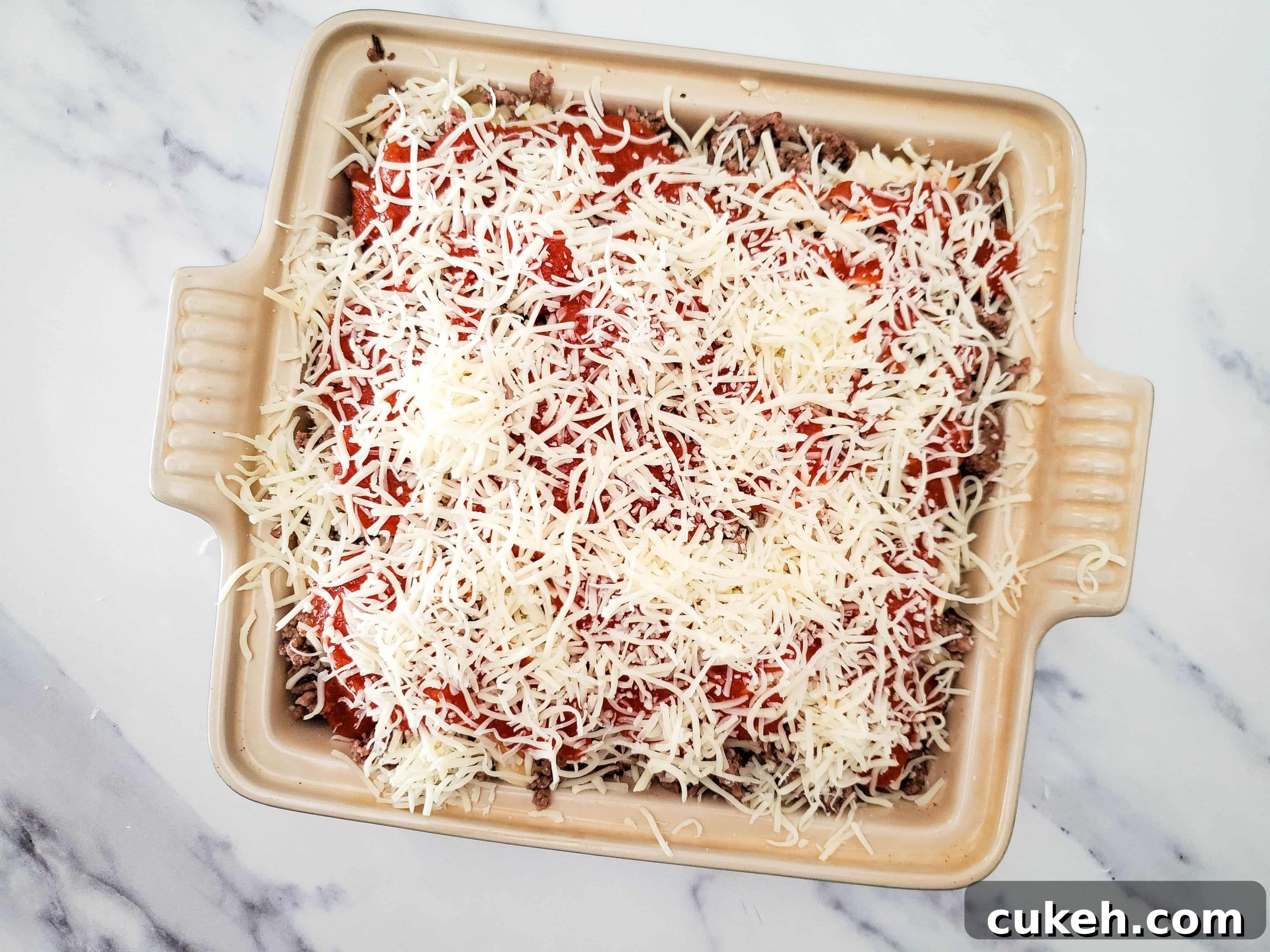 Casserole baking dish with layers of frozen ravioli lasagna