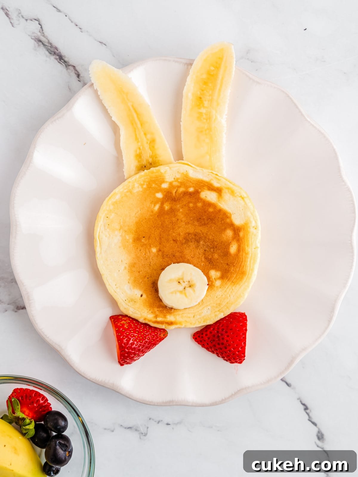 Add halved strawberry bowtie and banana nose
