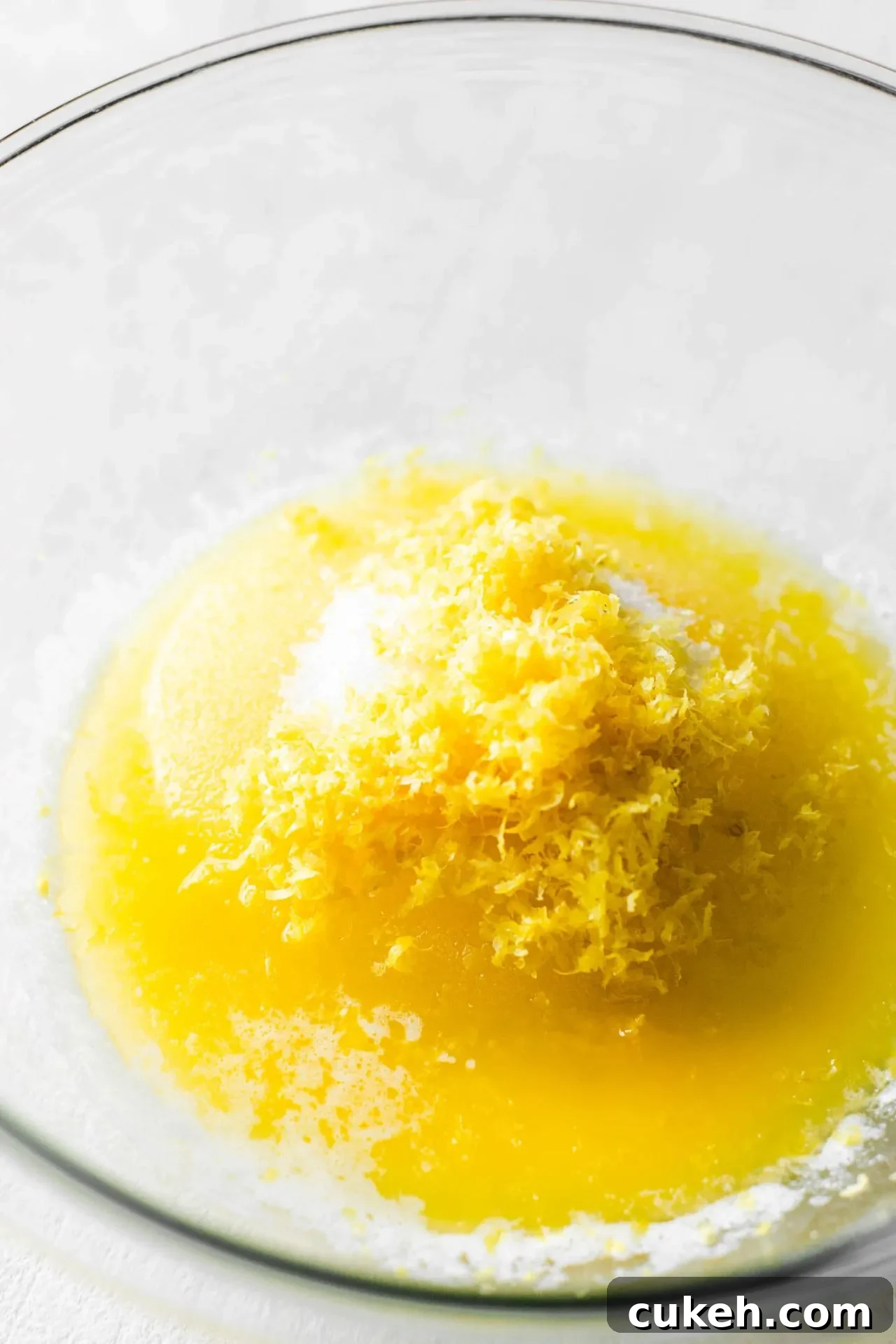 melted butter, sugar, and lemon zest combined in bowl