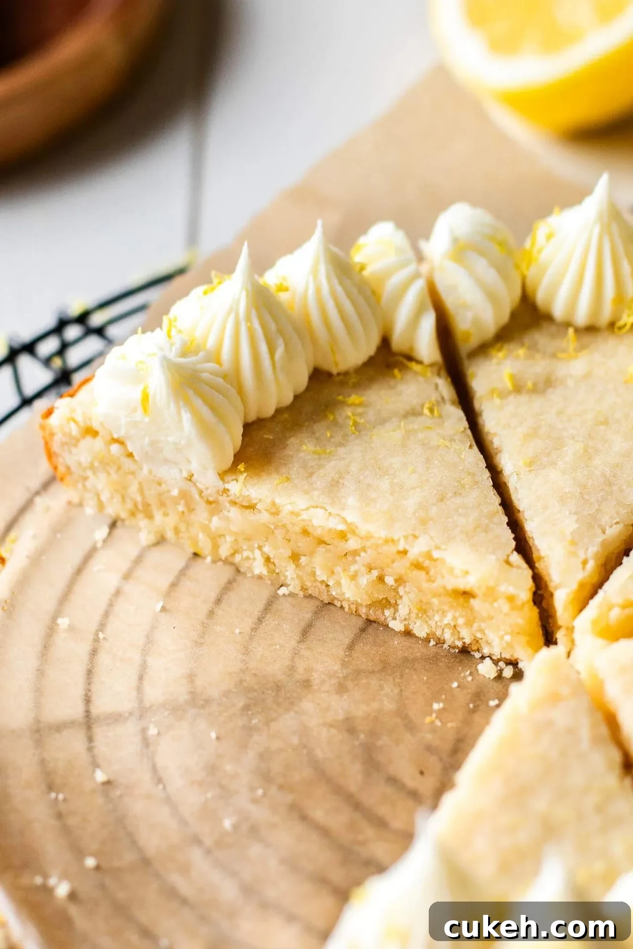 sliced Giant Lemon Cookie Cake on parchment lined wire rack