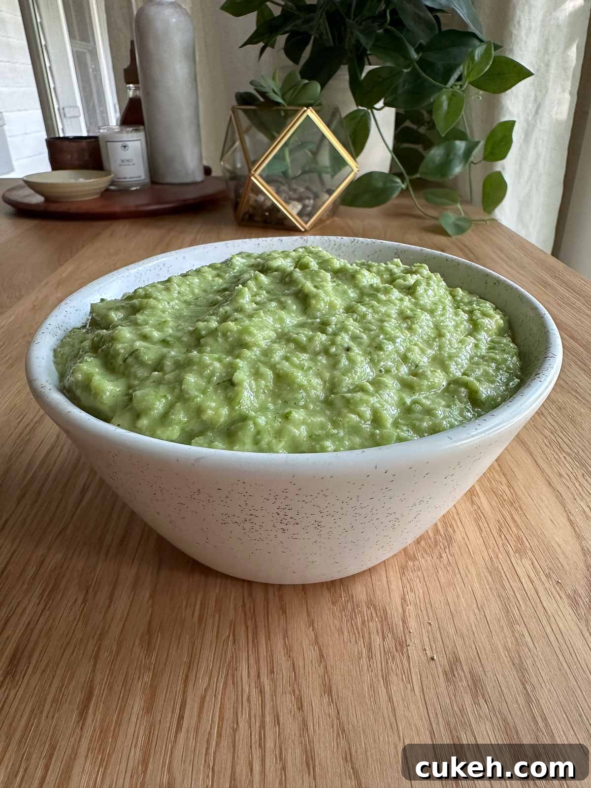 a bowl with garlic scape pesto on a table