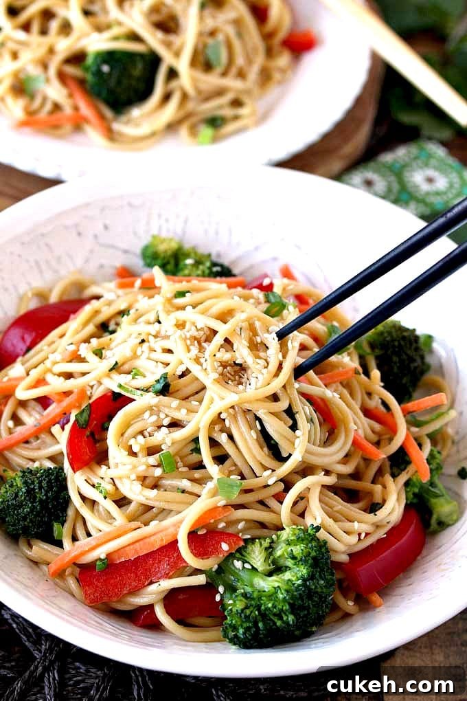 Asian noodles lifted with chopsticks.